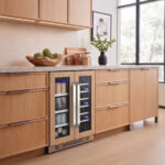 Dual-zone beverage center featuring wood-paneled door frames to match natural oak kitchen drawers and cabinetry.