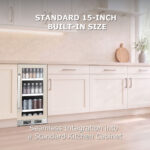Beverage refrigerator with a stainless steel handle installed flush under a wooden kitchen countertop between white cabinets, highlighting its standard 15-inch built-in size.
