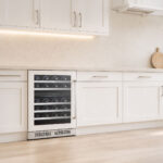 Straight-on shot of the dual-zone beverage and wine cooler fitted flush beneath shaker kitchen cabinets.