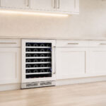 Straight-on shot of the dual-zone wine cooler fitted flush beneath gray shaker kitchen cabinets.