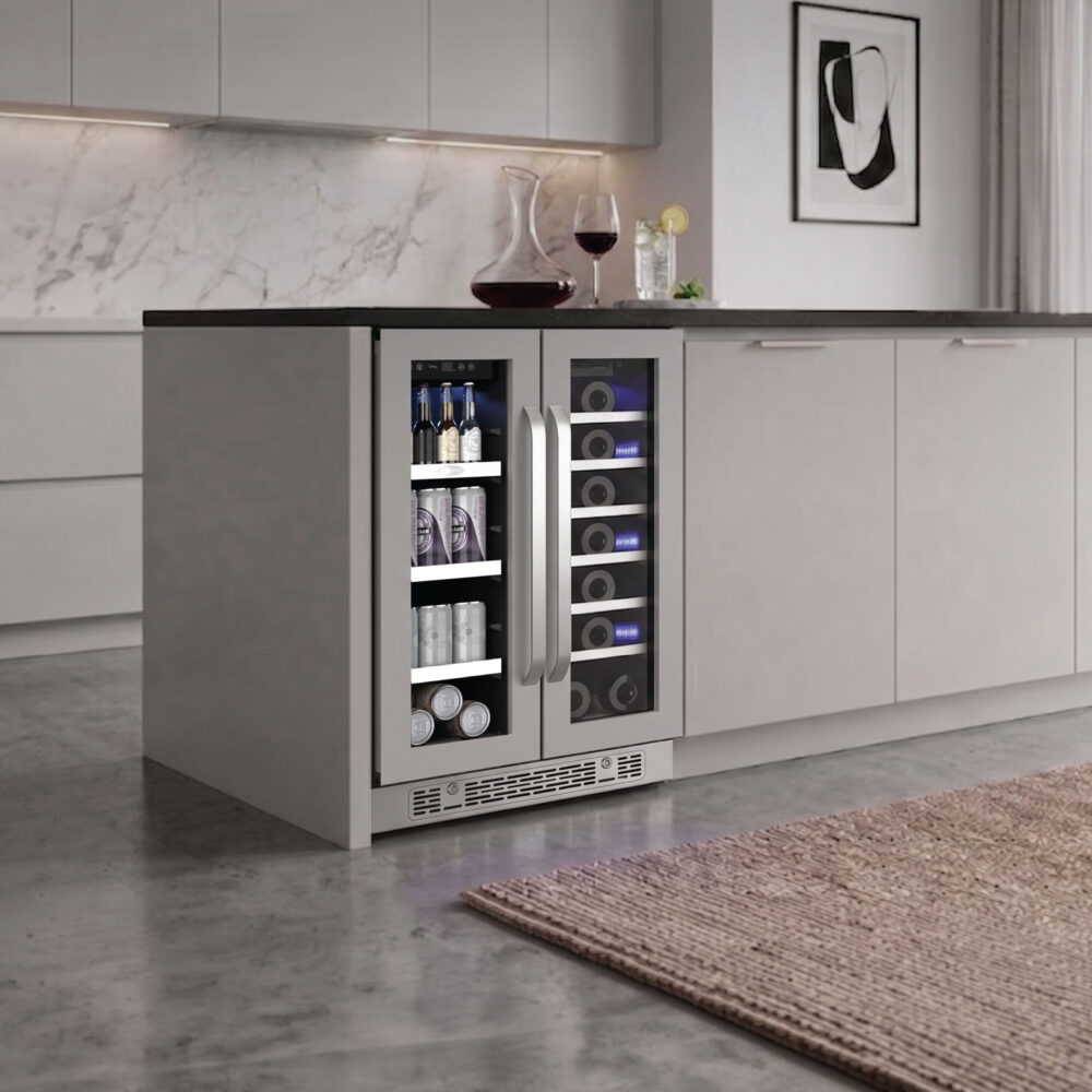 Under-counter beverage and wine cooler fitted into a contemporary gray kitchen island, illuminated with cool blue interior lighting.